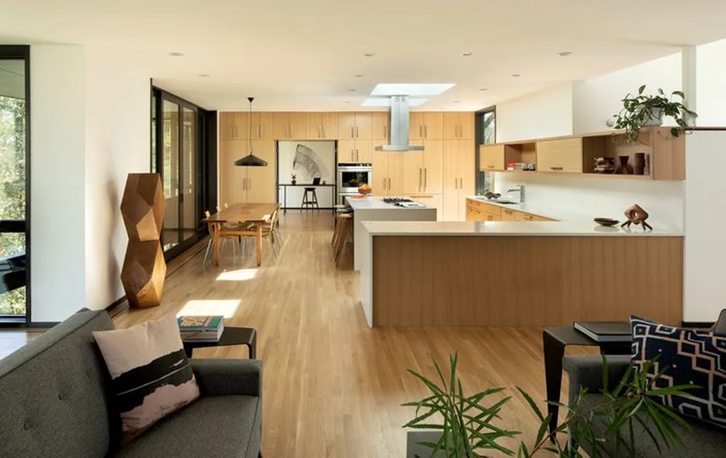 Open-plan kitchen with painted cabinetry, a long island and a wood ceiling