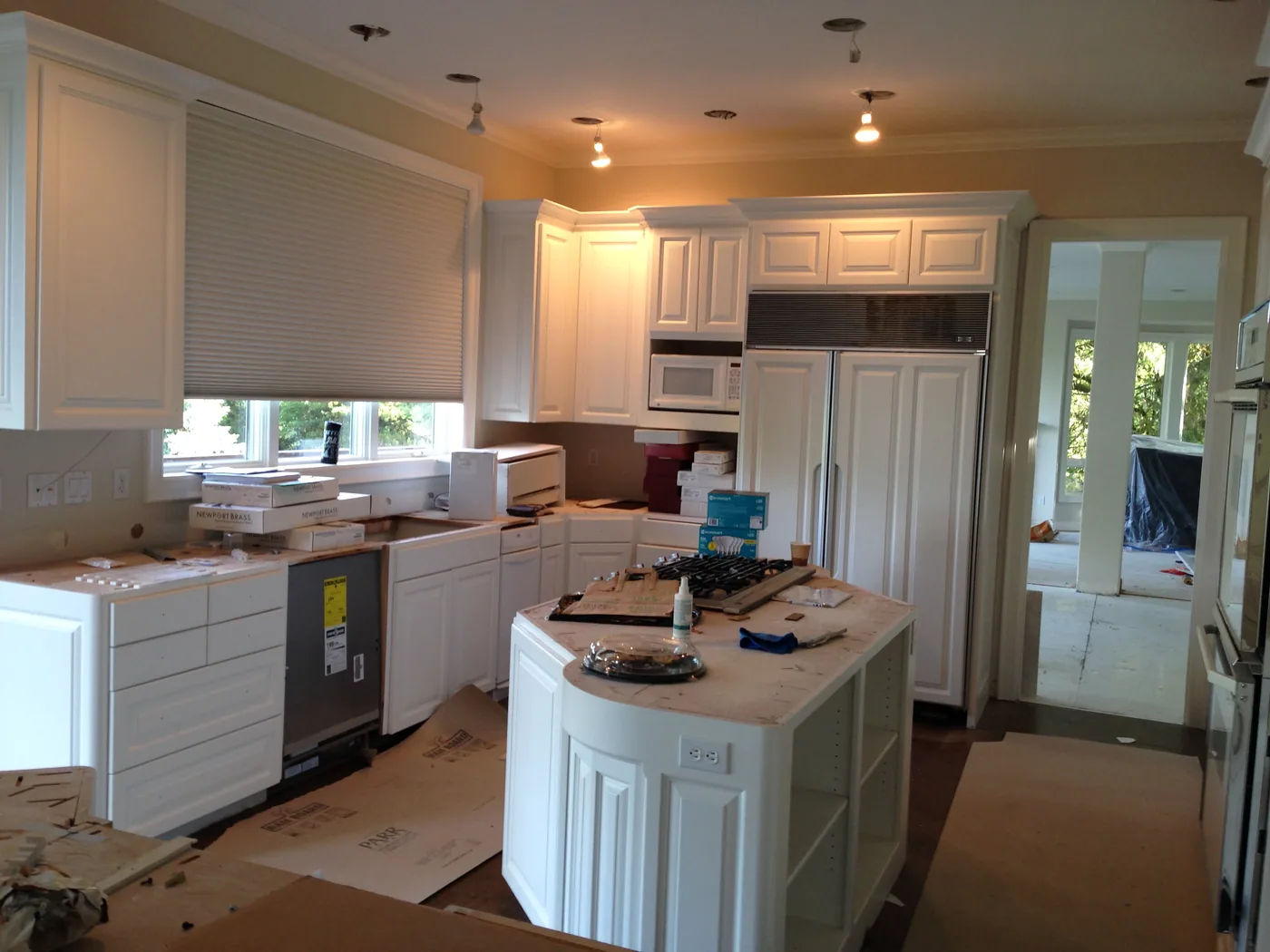 Kitchen cabinets masked and part way through a repaint by G & F Painting