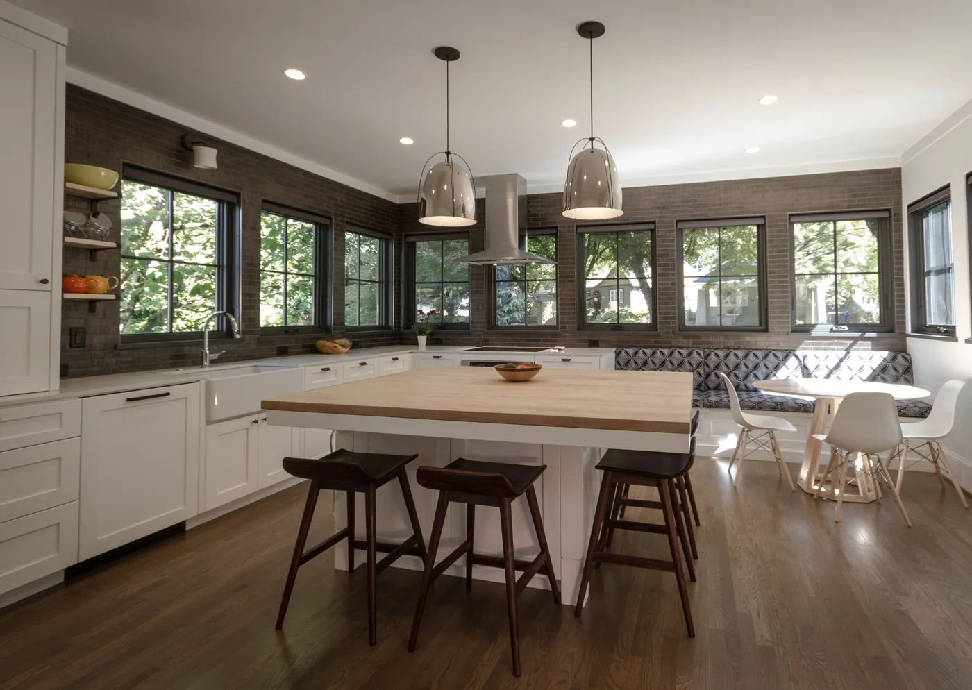 Painted kitchen island and cabinetry under pendant lights