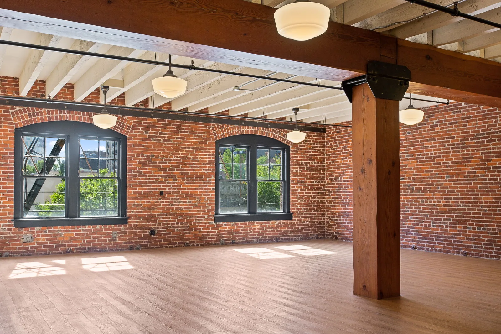 Brick and timber loft office with a freshly painted white ceiling