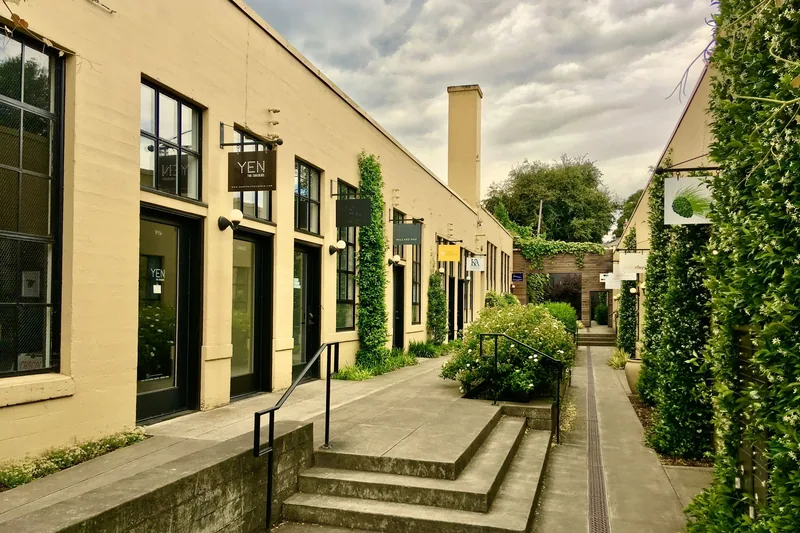 Courtyard between commercial buildings with painted trim and doors