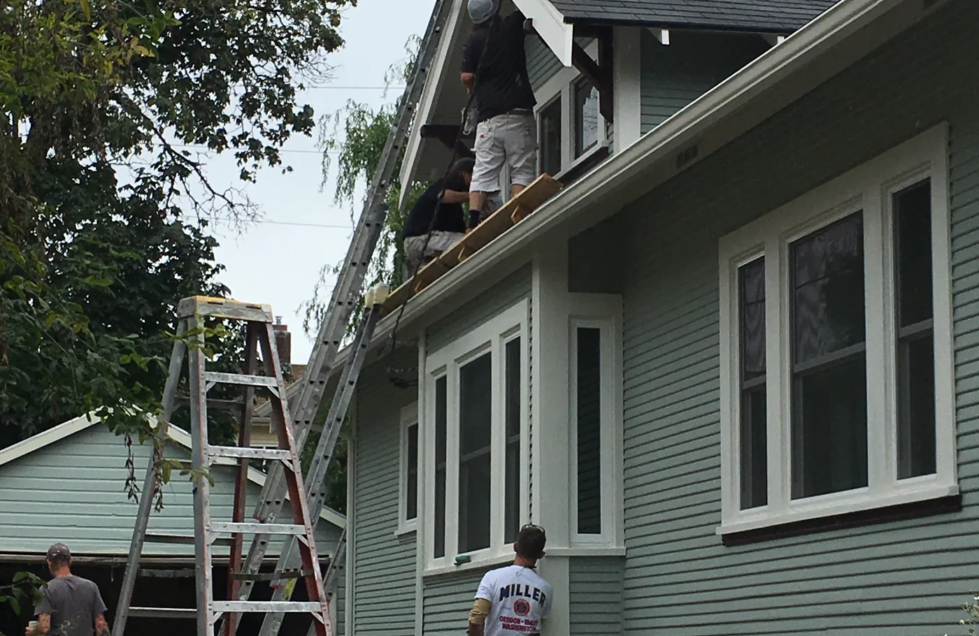 Ladders set against a Portland home during an exterior repaint