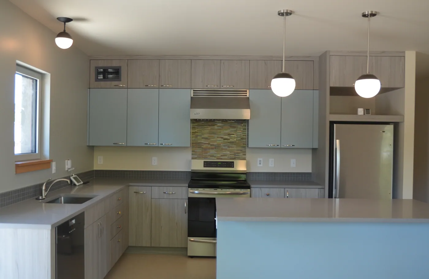 Kitchen with painted cabinets and a pale grey island