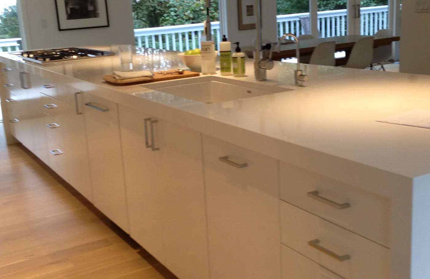 White cabinets along a long waterfall island