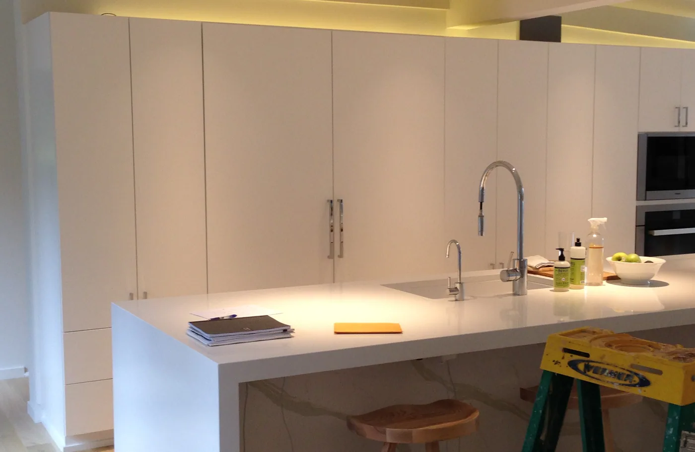Tall white cabinets mid-project with a step ladder