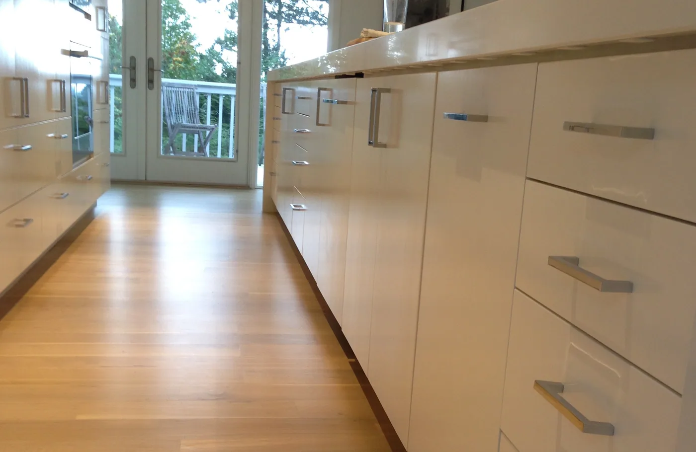 Row of white drawers down a galley kitchen