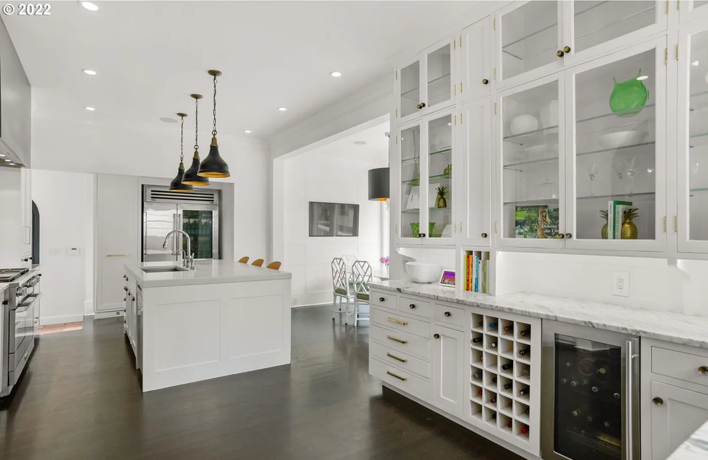 White kitchen with glass-front cabinets and a wine rack