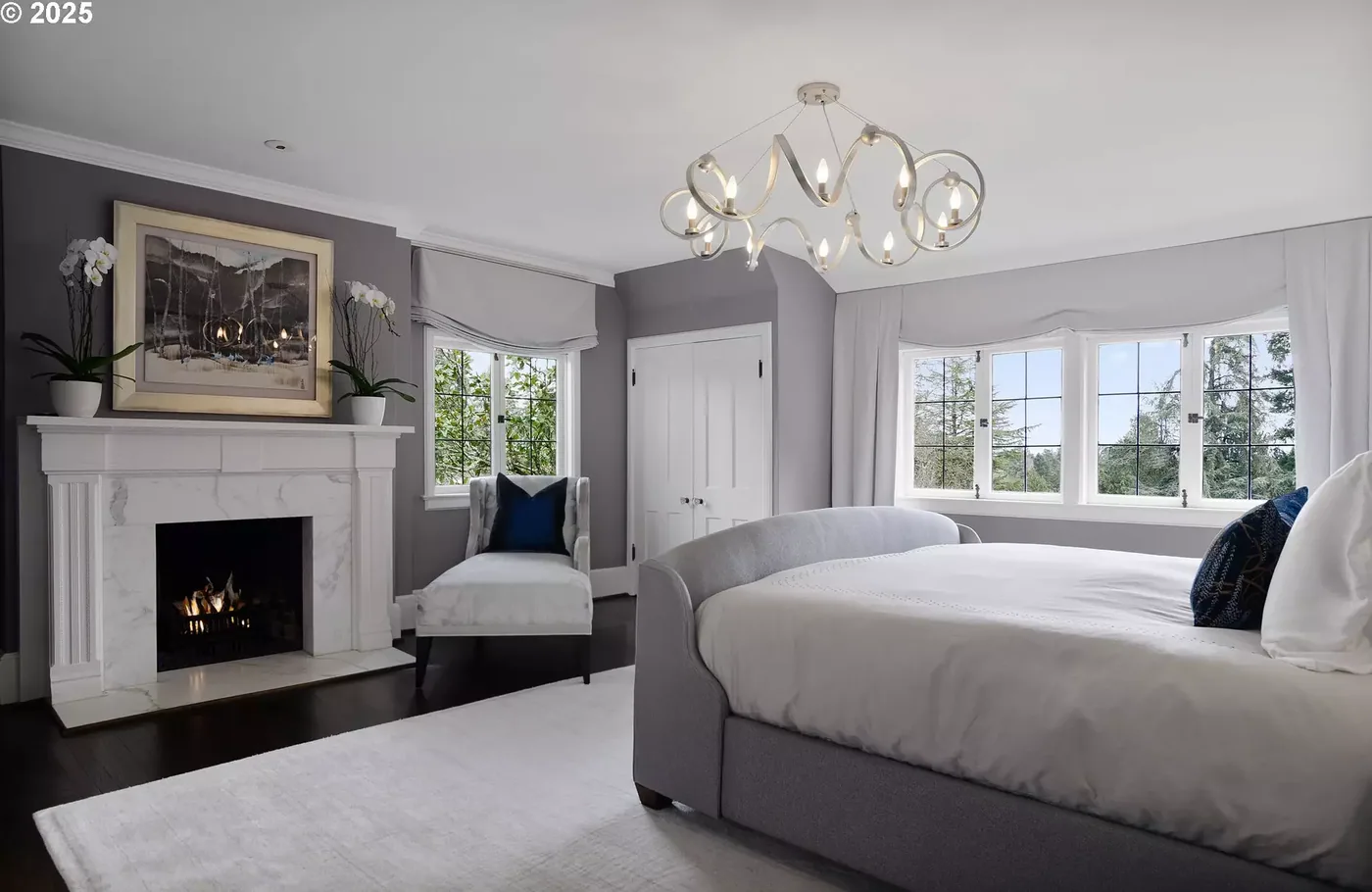 Bedroom with grey walls and a painted fireplace