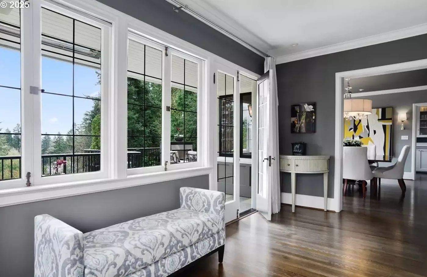 Sitting area with grey walls and painted windows