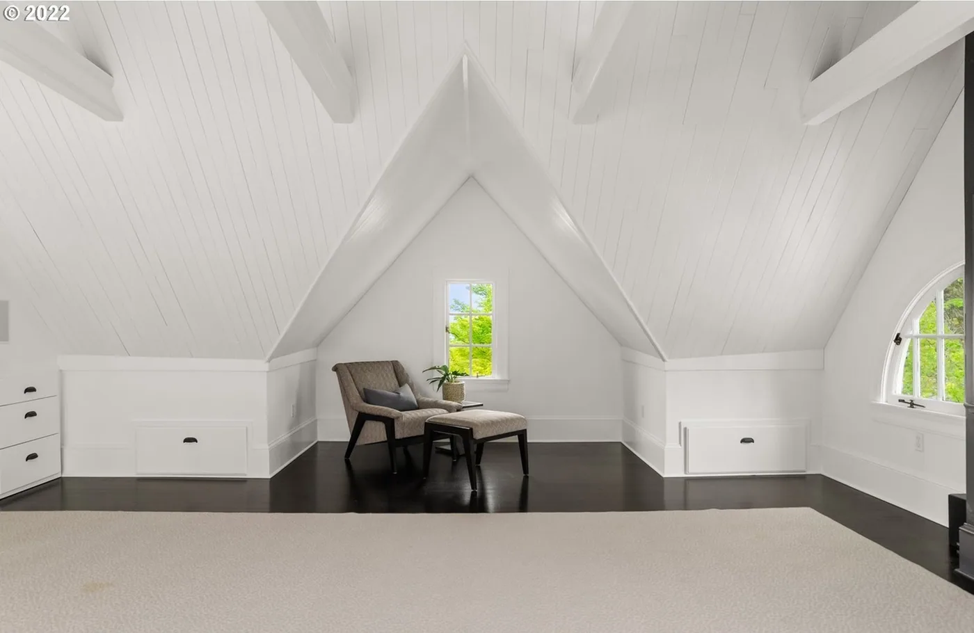 Attic room with painted ceiling and beams
