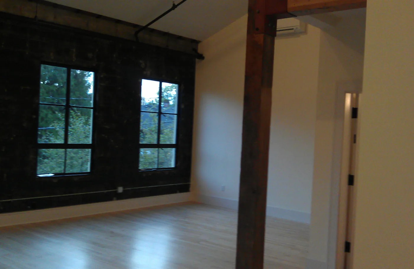 Loft with exposed brick, a timber beam and freshly painted walls