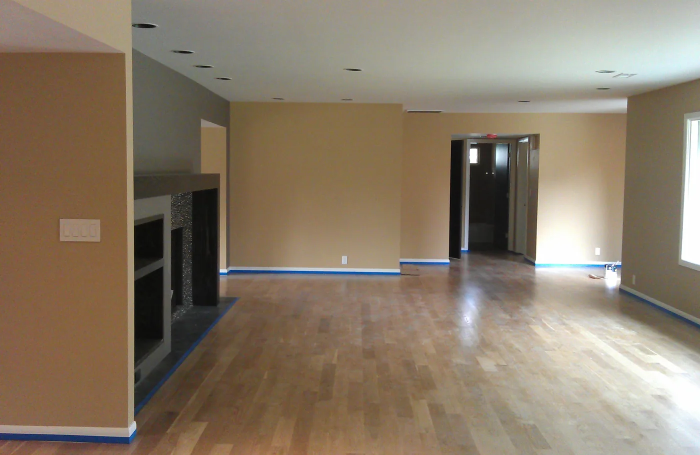 Living room walls painted and taped off, ready for the floors
