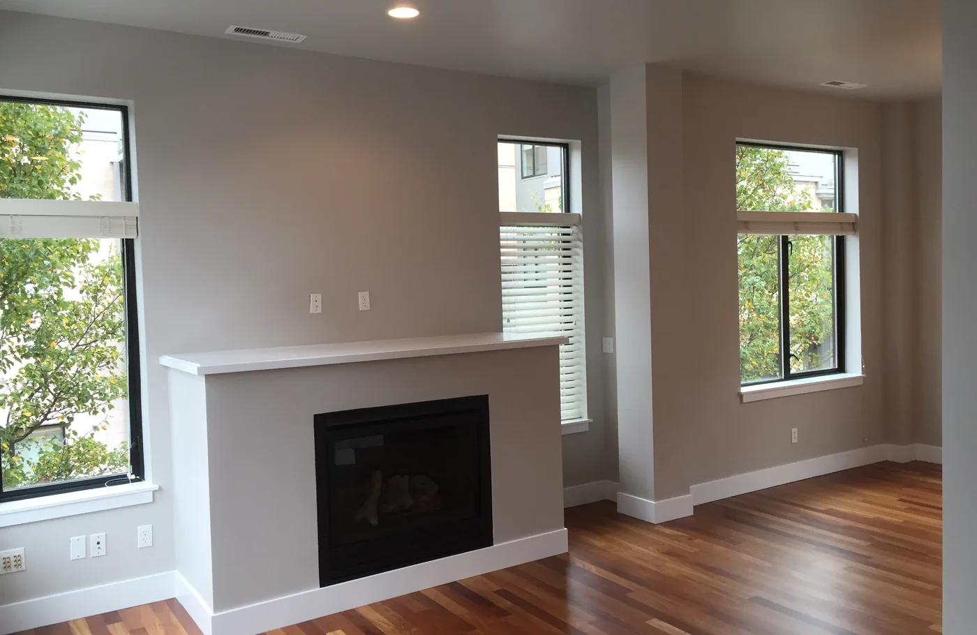 Living room with a painted fireplace surround and white trim