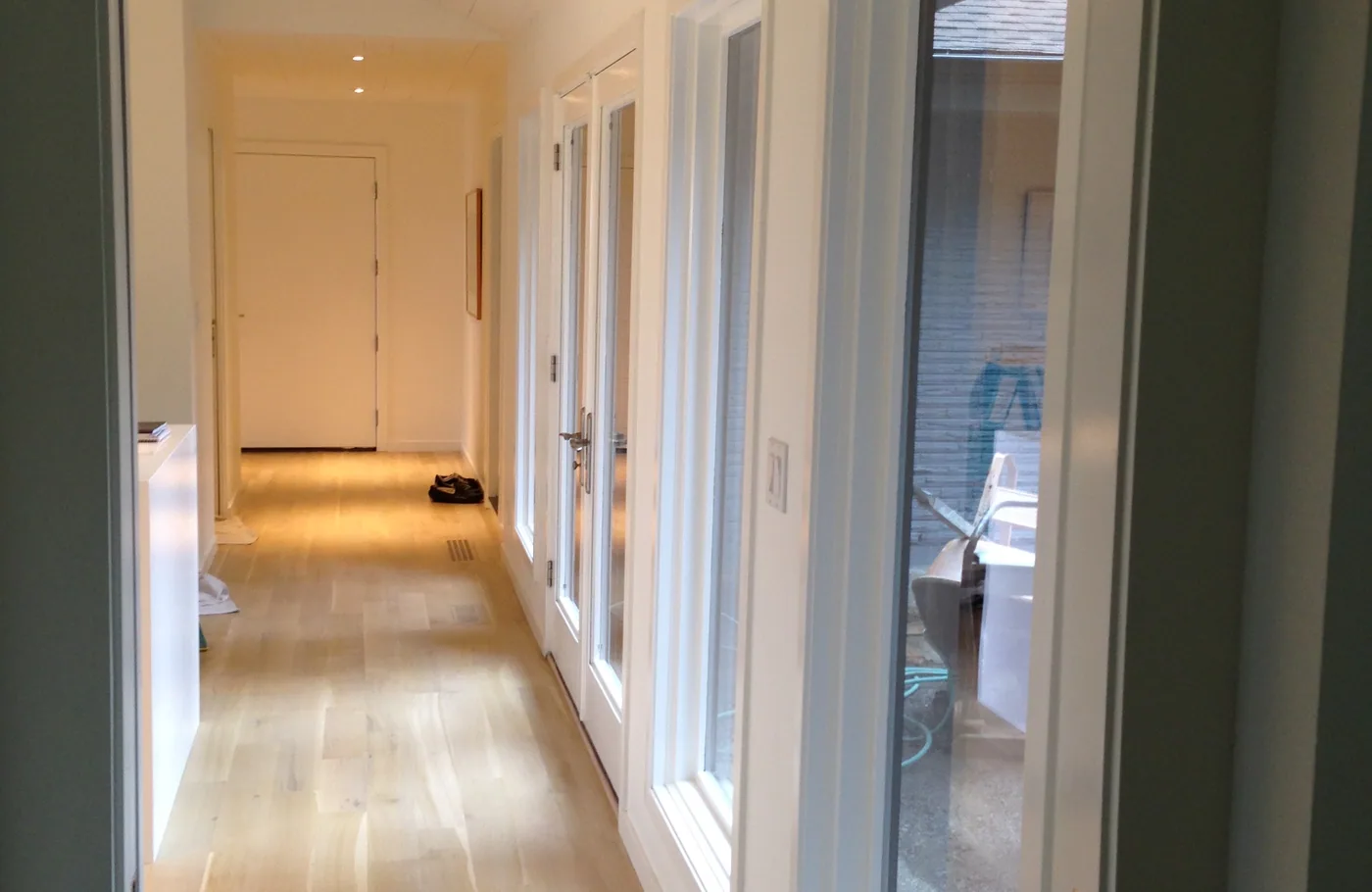 Long white hallway with fresh paint and trim