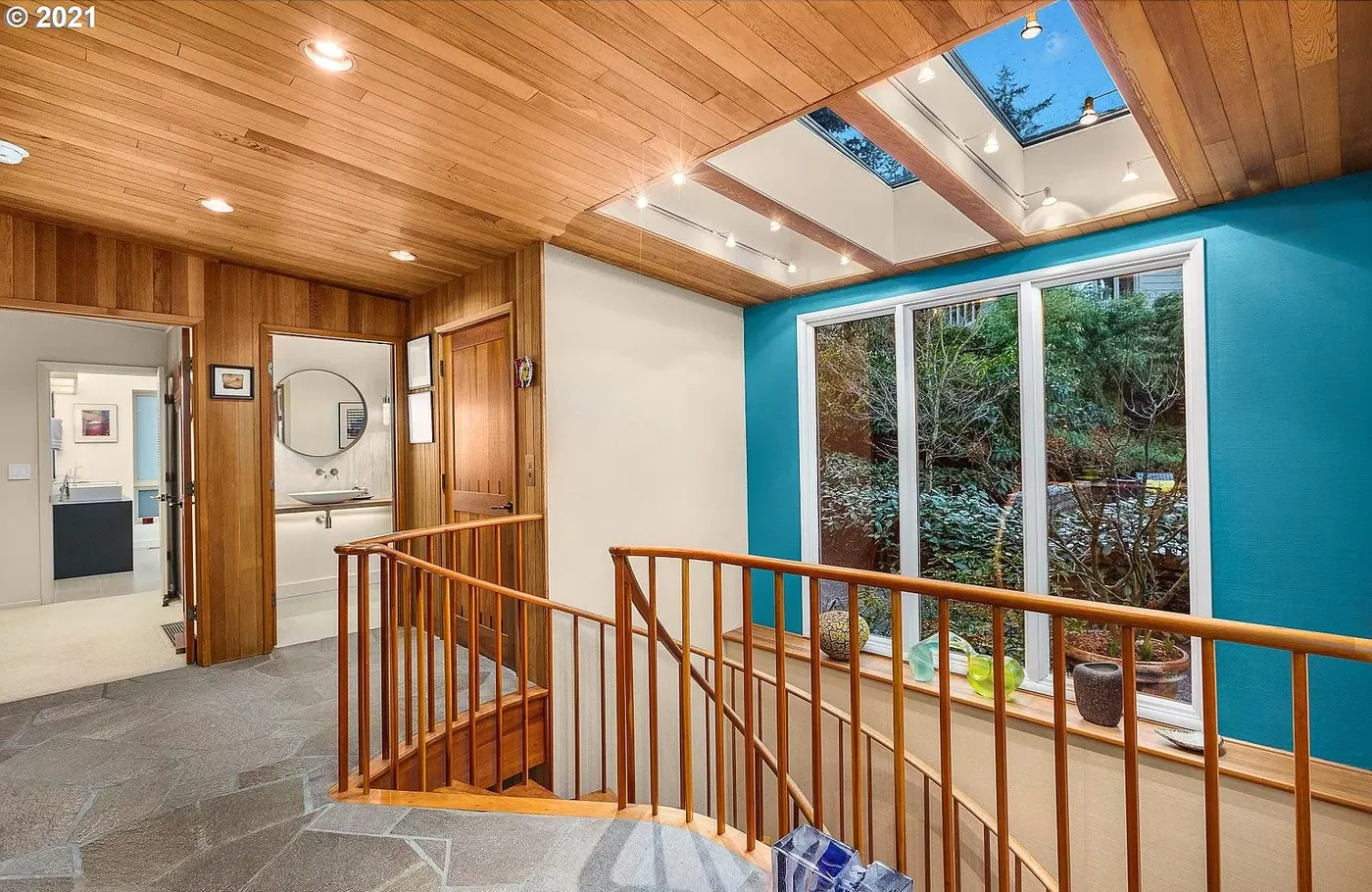 Stair landing with a teal accent wall