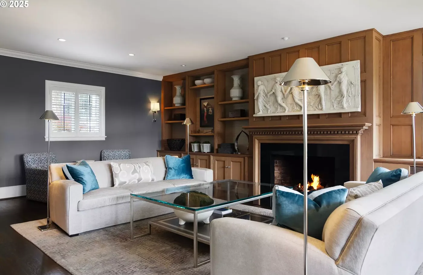 Stained wood paneling and built-ins around a fireplace