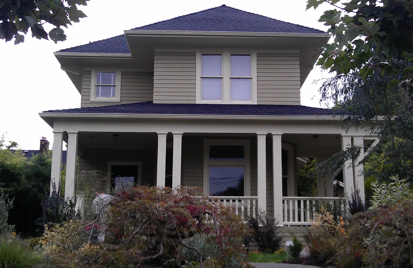Foursquare home with a wide front porch and fresh exterior paint