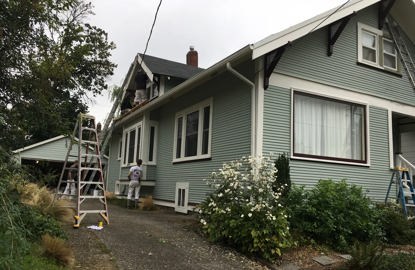 Ladders set up along a Portland home during an exterior repaint