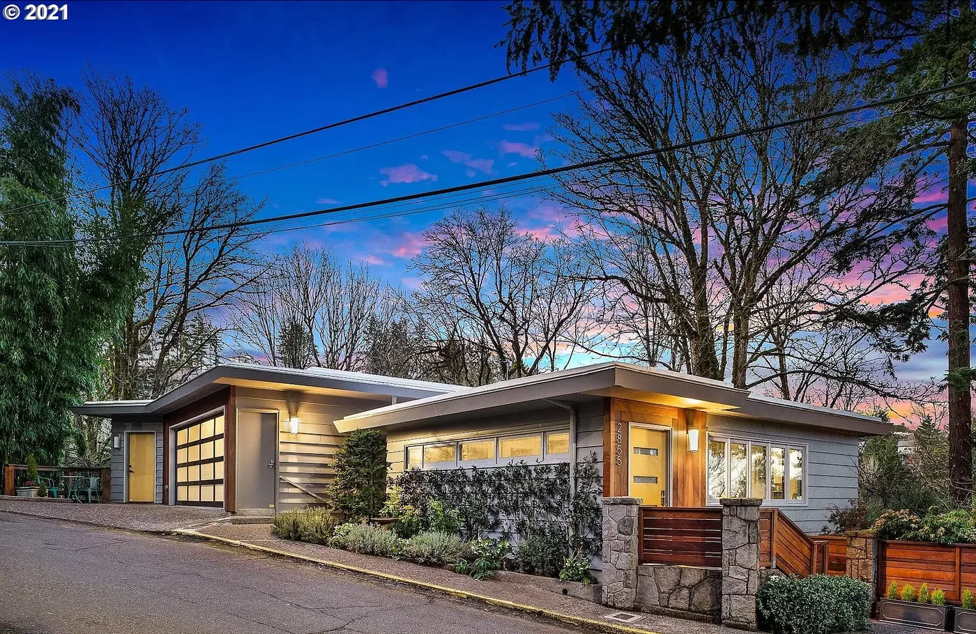 Low mid-century home and garage at dusk