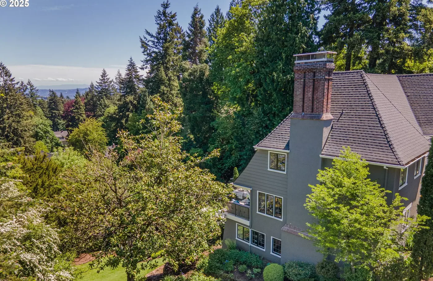 Grey home above a wooded garden