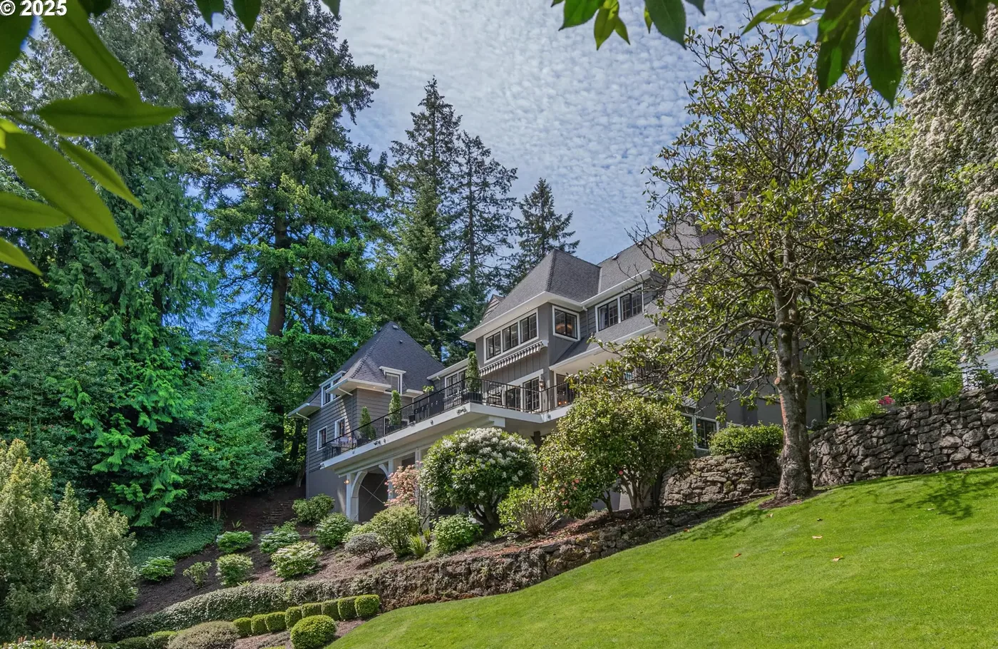 Grey estate home above a sweeping lawn