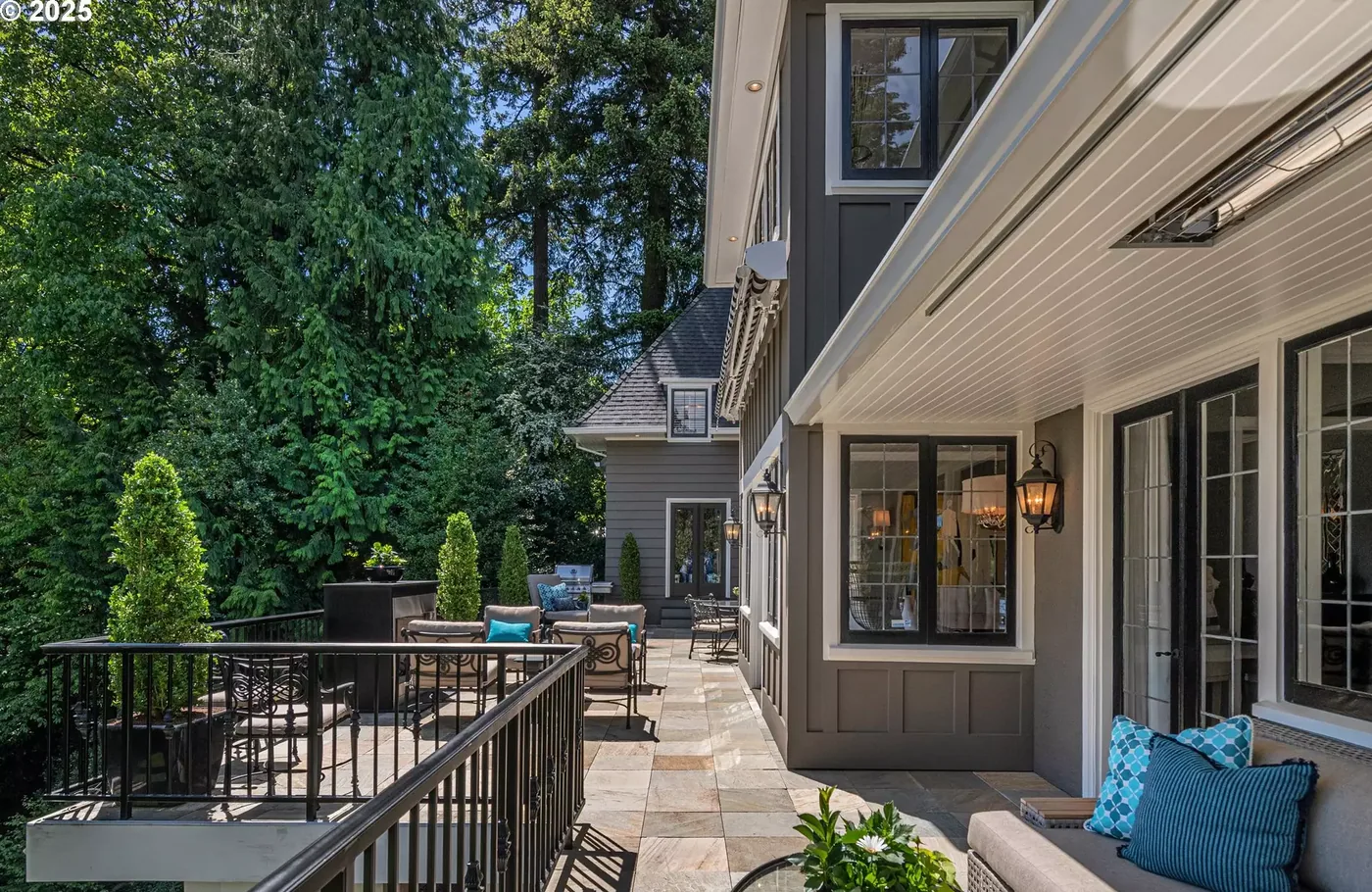 Painted trim and doors along a stone terrace