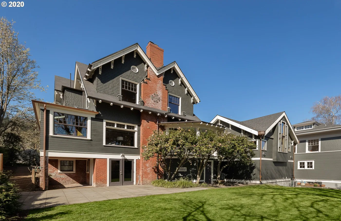 Craftsman home with brick and grey shingle