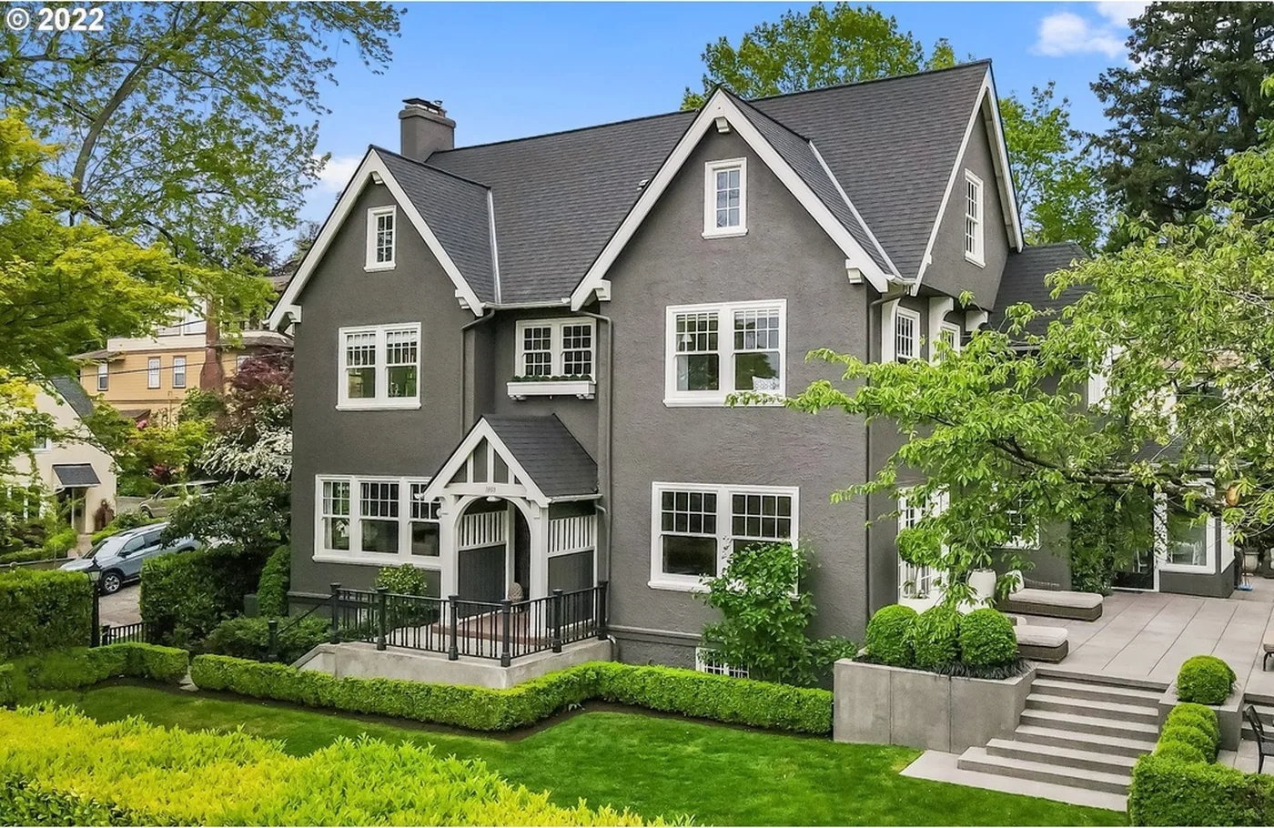 Dark grey Tudor home and front garden