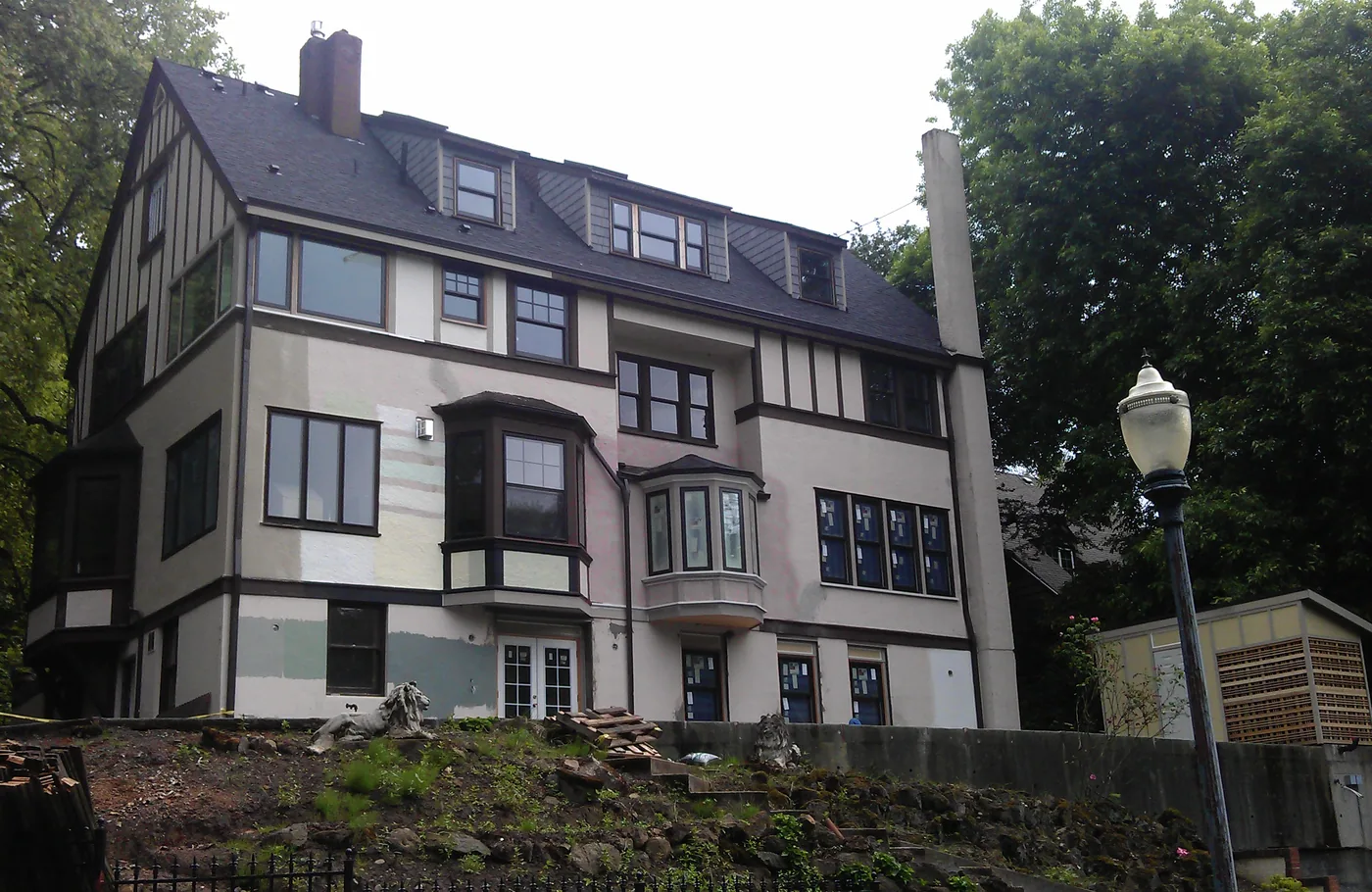 Large Portland Tudor with cream stucco and dark trim