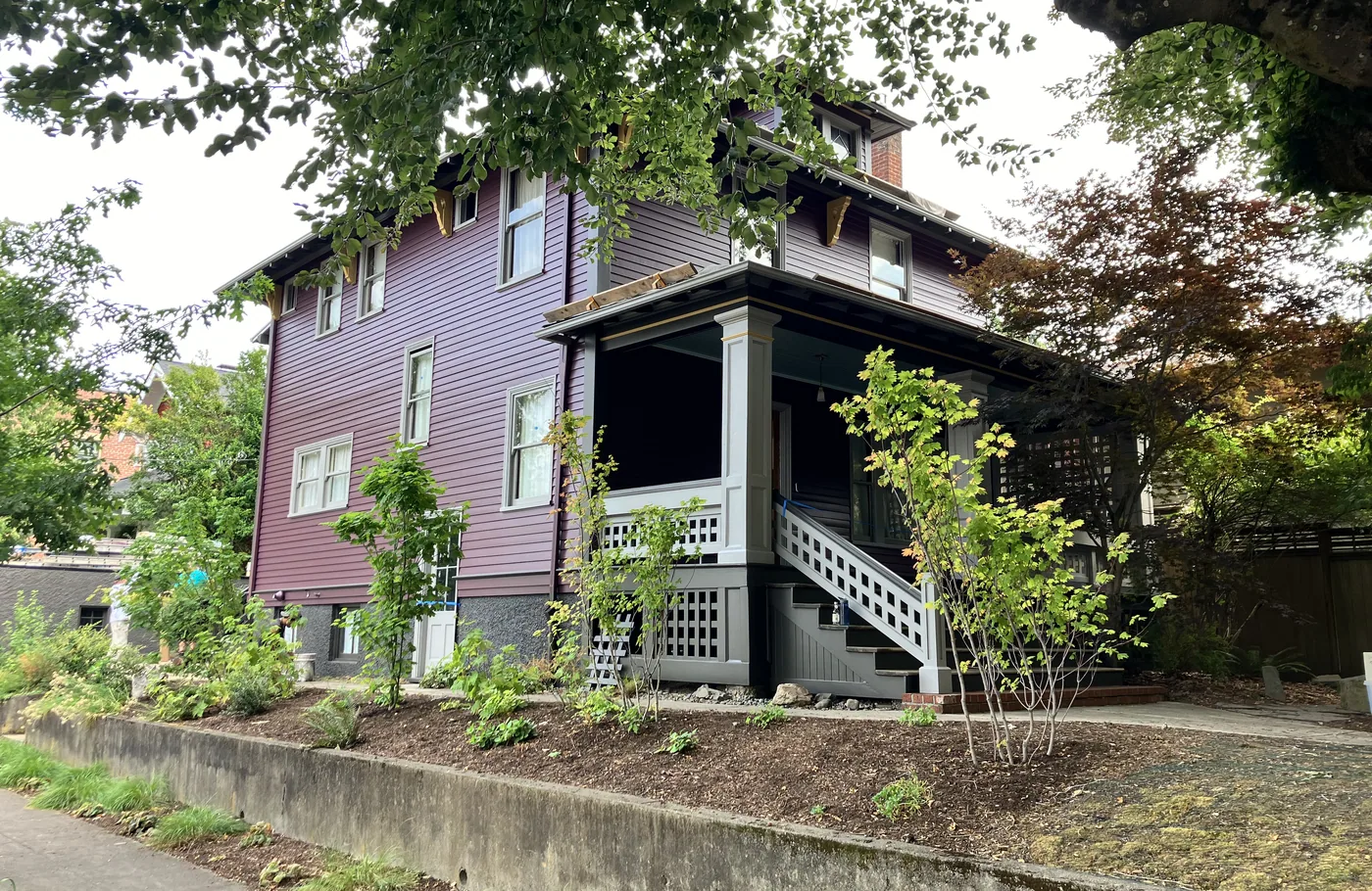 Plum-colored Portland home with a black and white porch