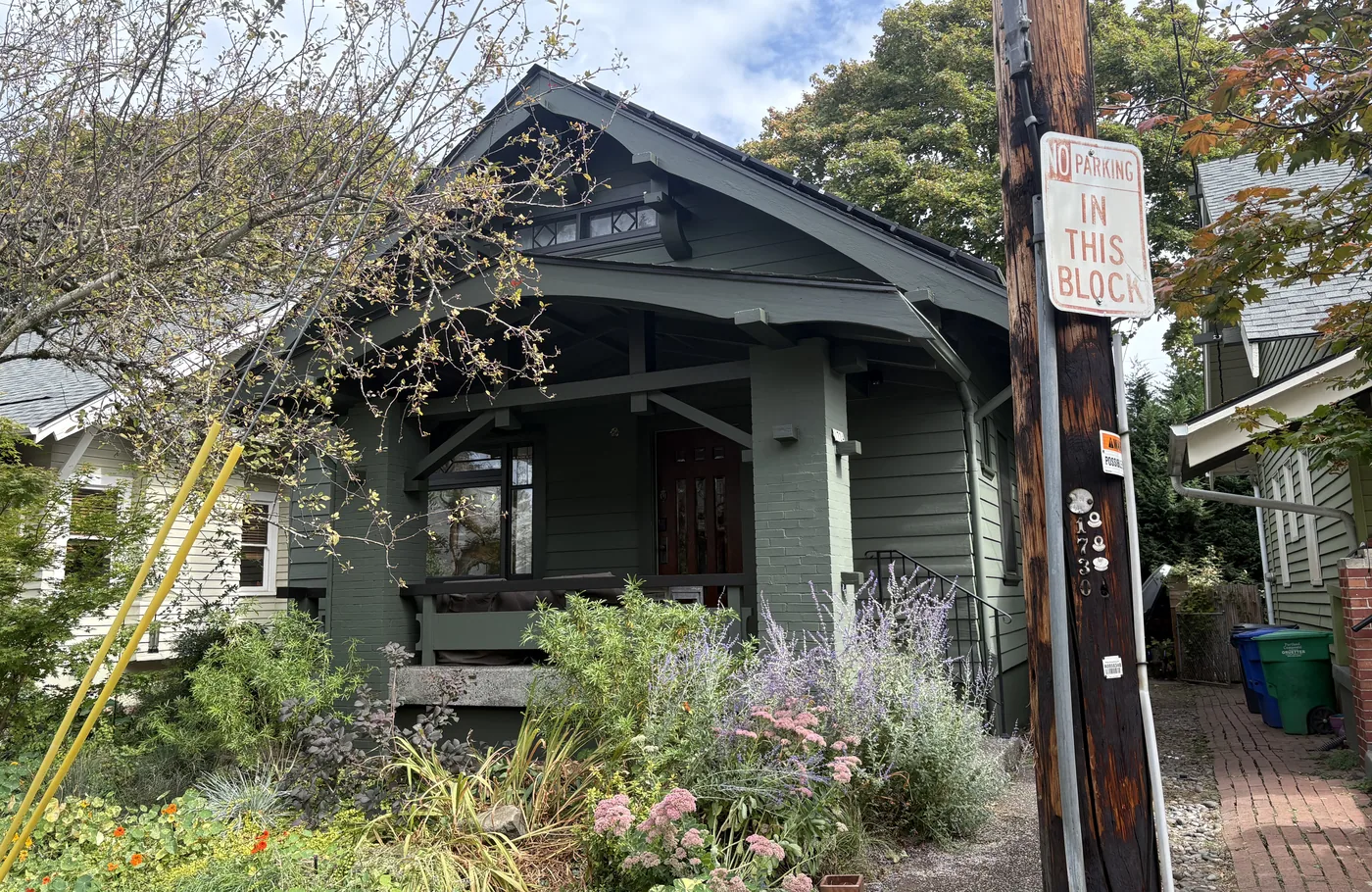 Sage-green Portland bungalow behind a cottage garden