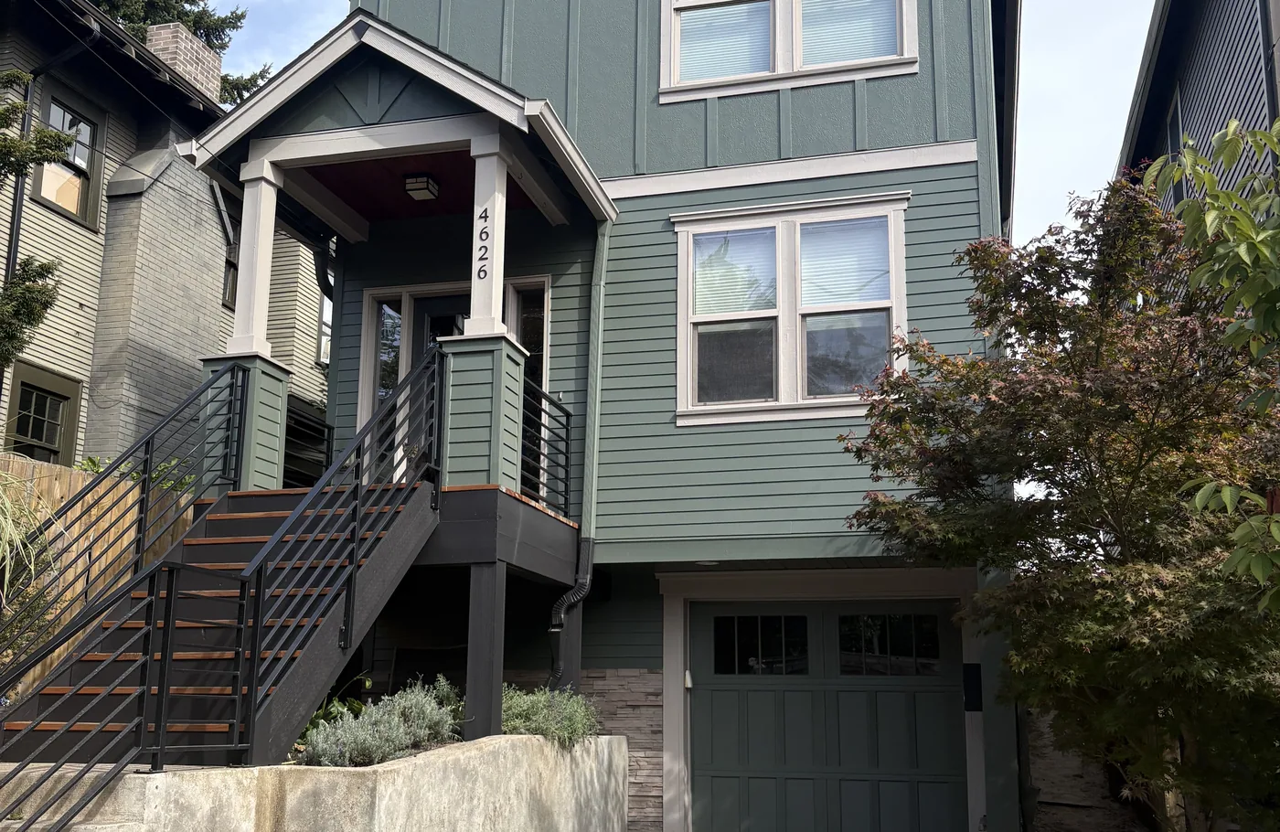 Tall Portland home finished in green with white trim