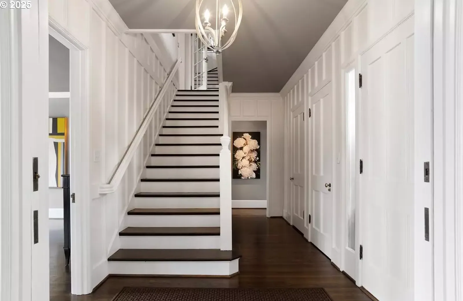White stair hall with painted wainscot and trim