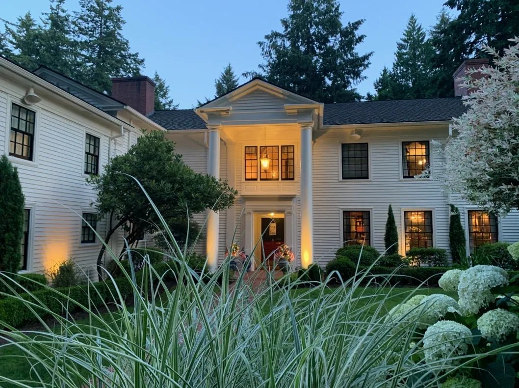 A repainted Portland home lit up at dusk